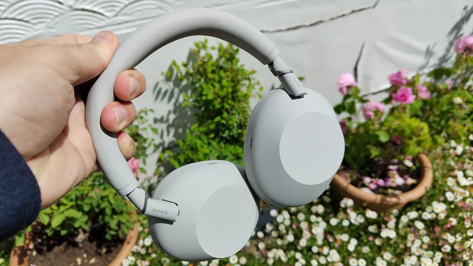Sony WH-1000XM5 and WH-1000XM6 headphones side by side on a white surface