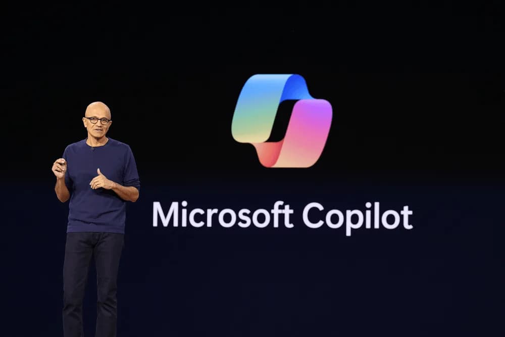 Microsoft CEO Satya Nadella speaking on stage at a technology conference
