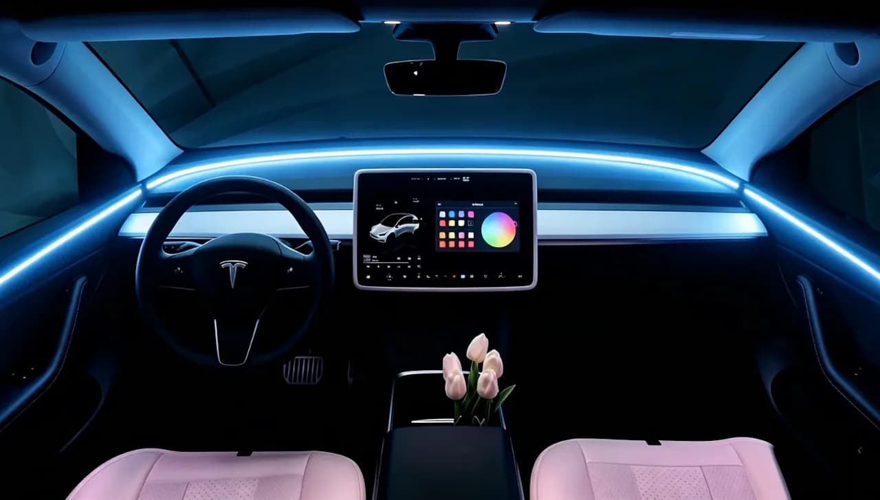 Star Ring Tesla ambient light kit installed in a Tesla Model Y interior, showing soft LED glow along door sills and footwells