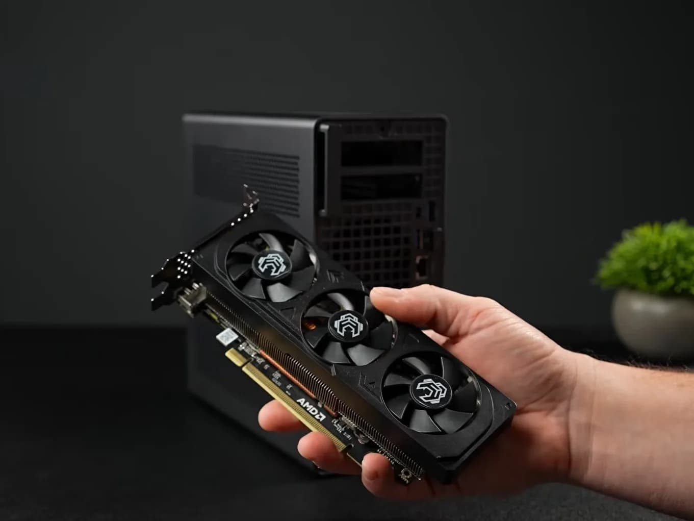 Minisforum MS-02 Ultra mini PC with AMD Radeon RX 9060 XT installed, shown beside a ruler for scale