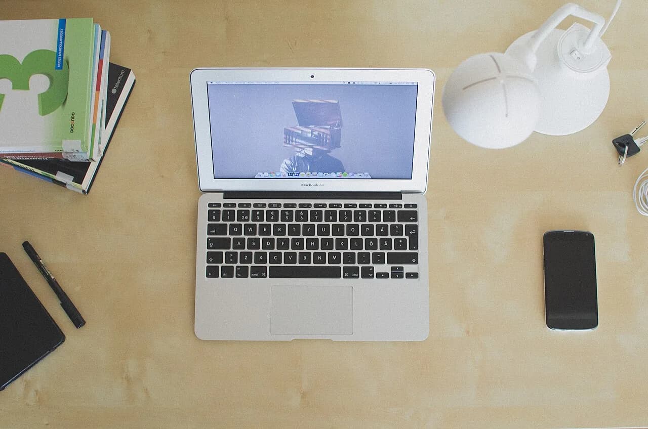 An open laptop on a wooden desk