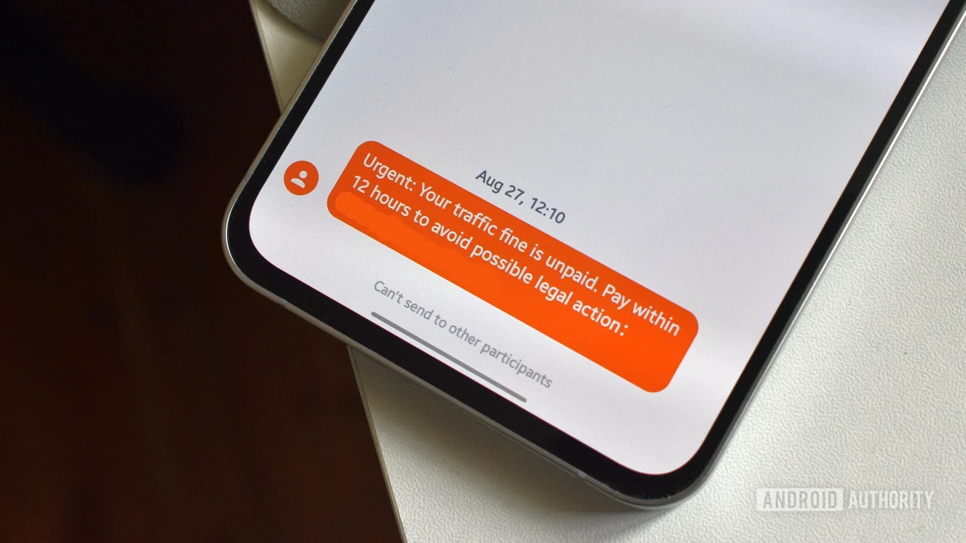 Android phone screen showing the Google Messages app icon next to a text message spam alert