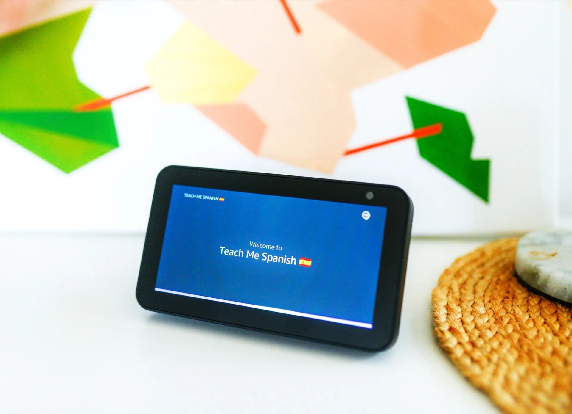 A smart home display mounted on a table stand in an open living room.