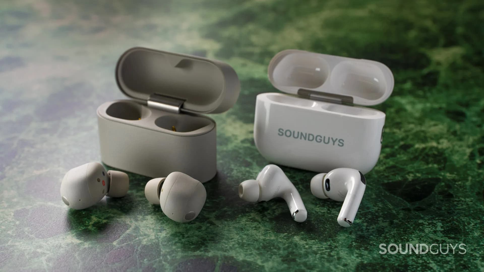 Pair of white wireless active noise cancelling earbuds resting on a flat reflective surface
