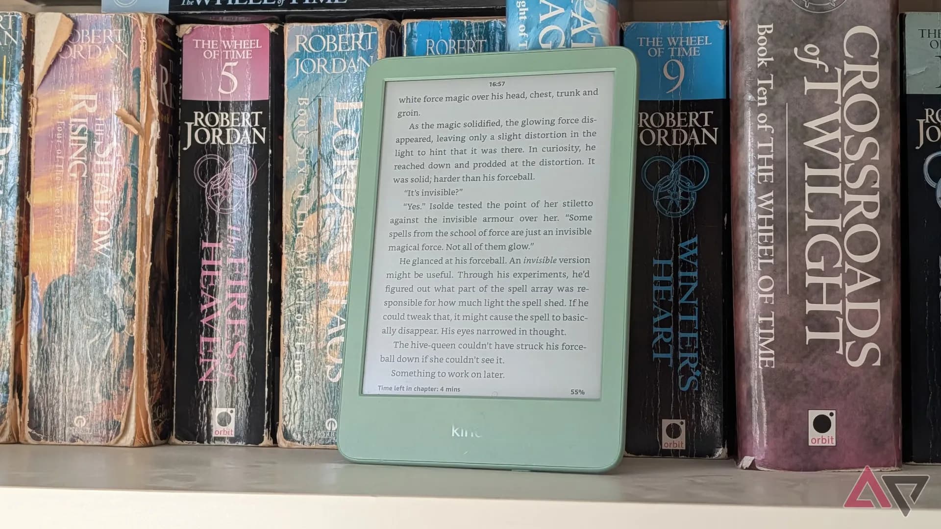 Amazon Kindle in Matcha green, resting on a stack of paperbacks