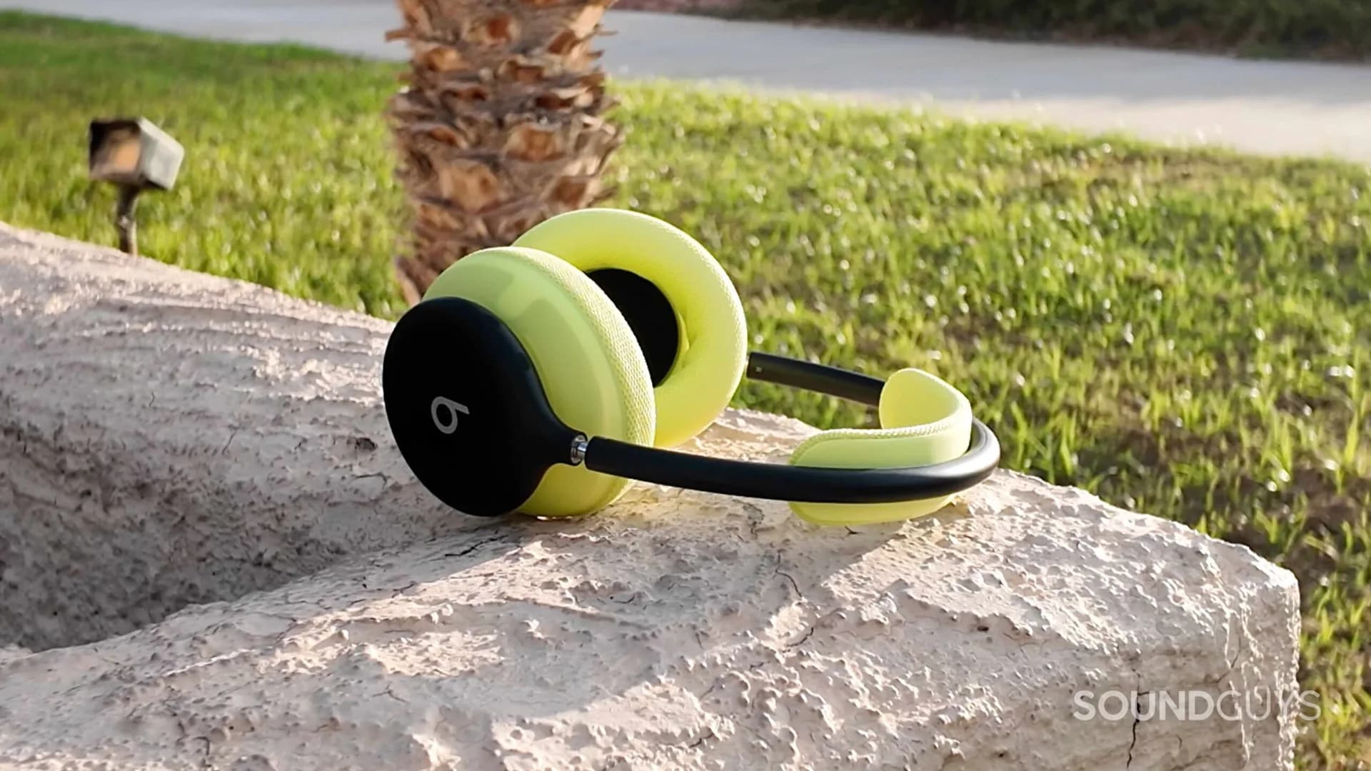 Beats 360 wireless over-ear headphones sitting on a plain surface showing ear cups and headband.