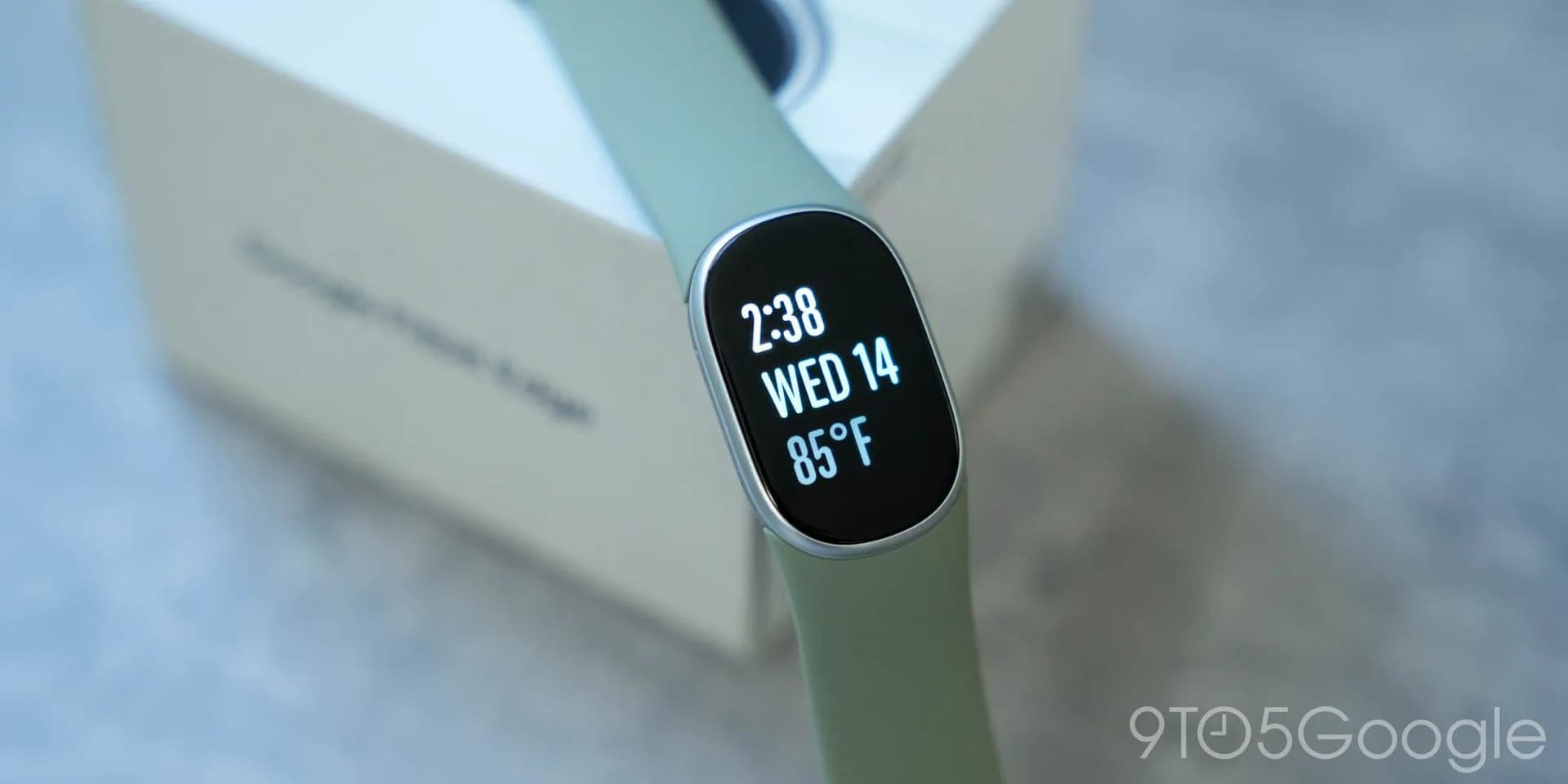Fitbit Edge tracker with a color display showing notifications and health metrics.