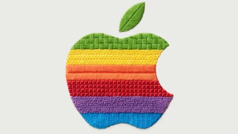 Apple logo projected onto a minimalist living room setup with smart lights and a small speaker on a shelf