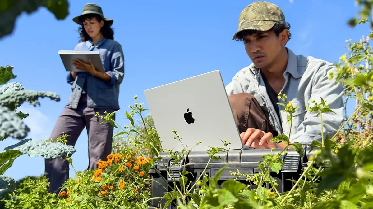 Apple's 14-inch MacBook Pro with M6 chip shown open on a desk in Space Black finish