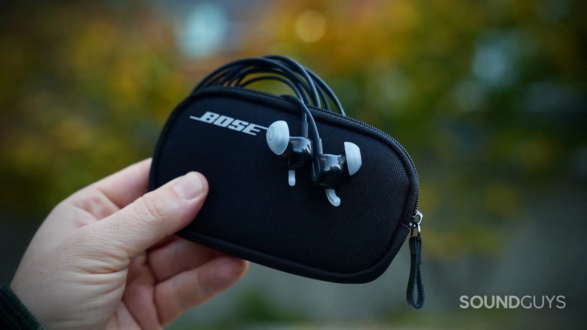 Bose Noise Cancelling Wired Earbuds with USB-C cable and inline remote laid out next to their carrying case