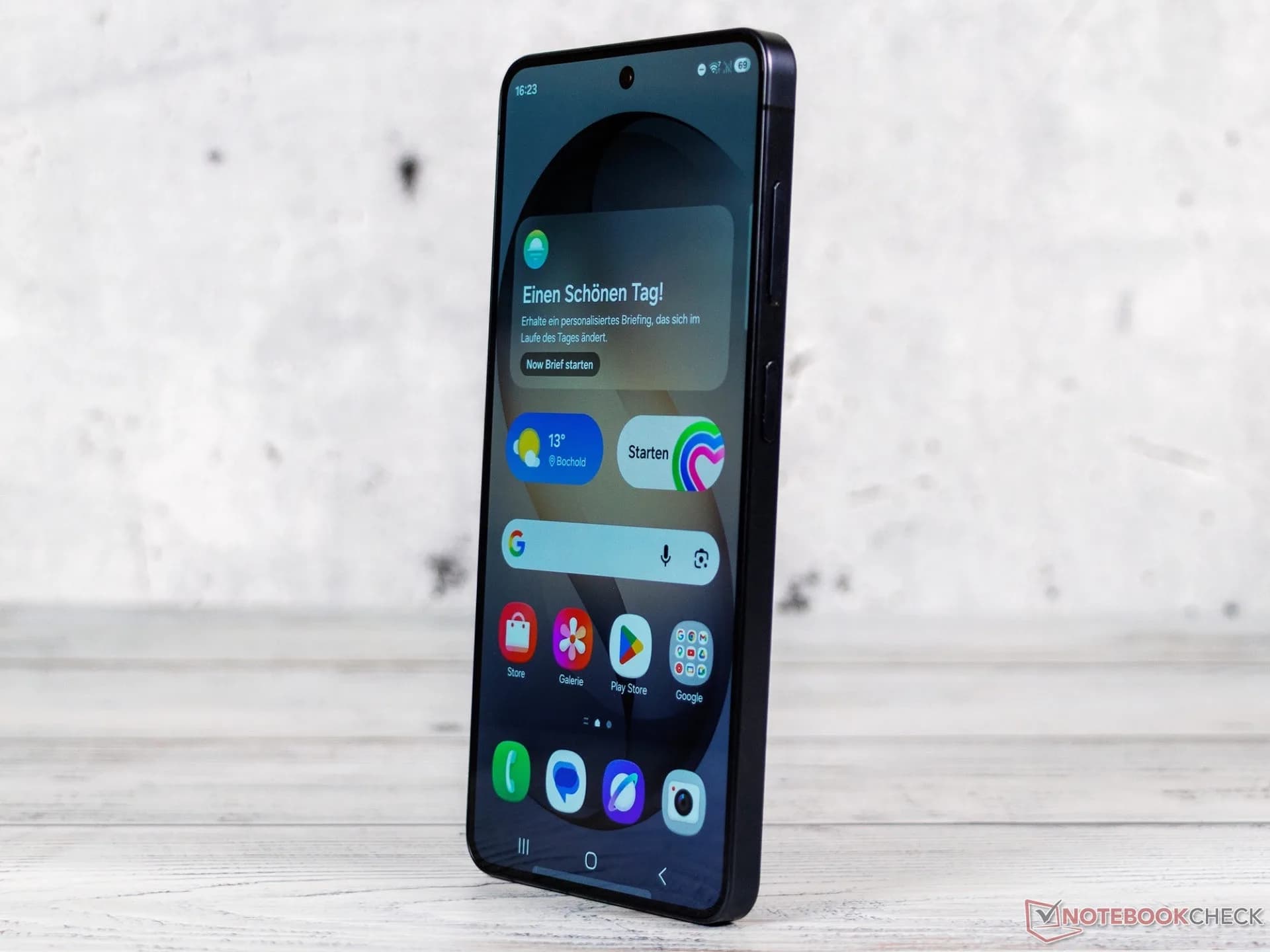 Close-up of the rear camera lenses on a Samsung Galaxy smartphone lying flat on a dark surface.