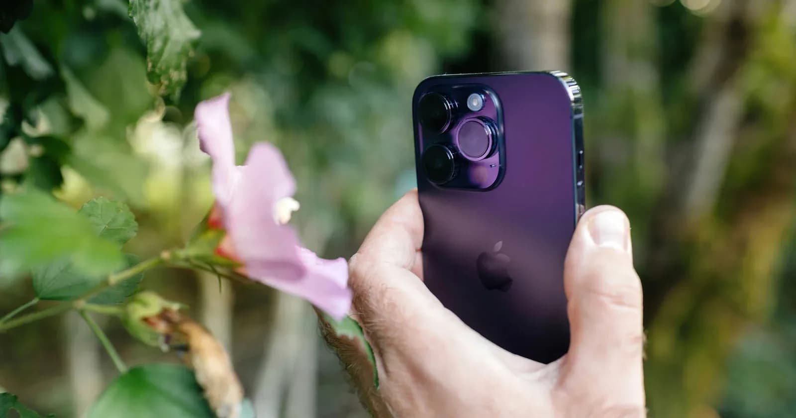 Close-up view of the rear camera lenses of an iPhone next to a magnetic phone mount