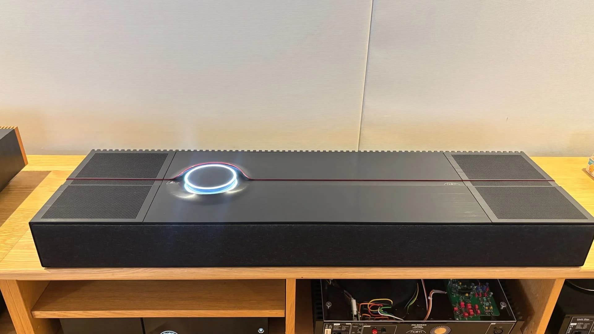 The Naim Mu-so Utopia all-in-one wireless speaker showing its aluminium chassis and illuminated dial