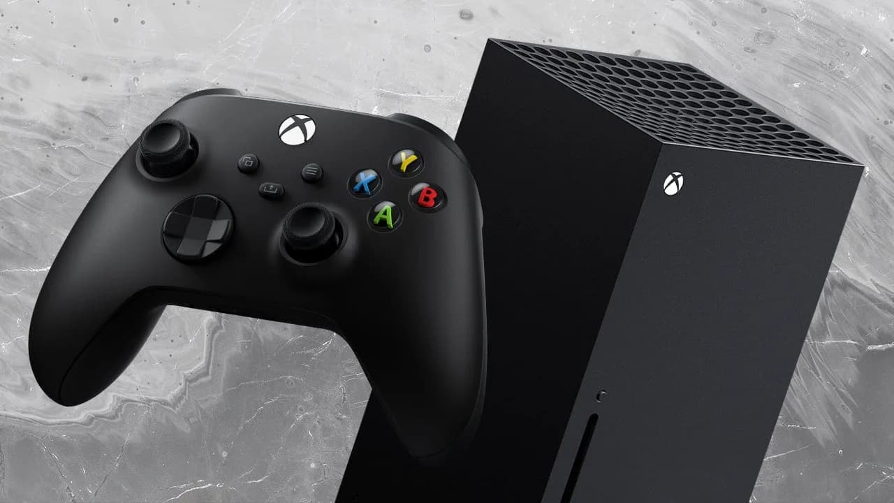 Close-up of an Xbox Series X console sitting horizontally near a gaming display.