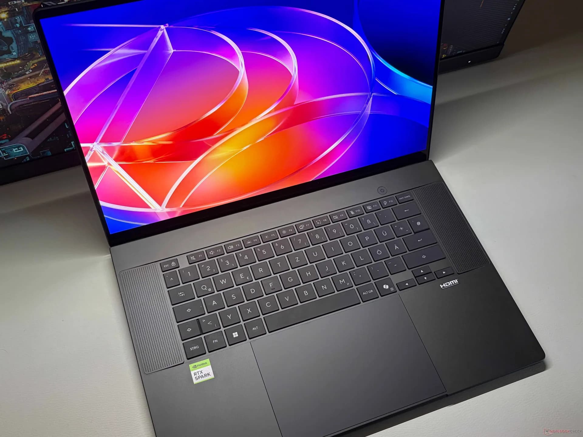Asus ProArt P16 laptop open on a desk showing its OLED touchscreen display