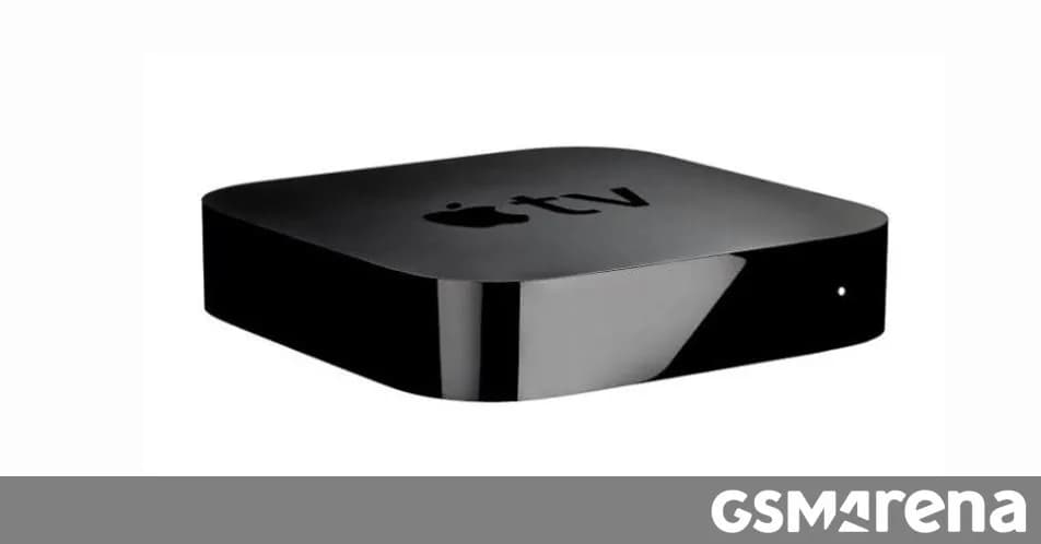 Apple TV 4K (2017) on a black shelf beside a modern remote