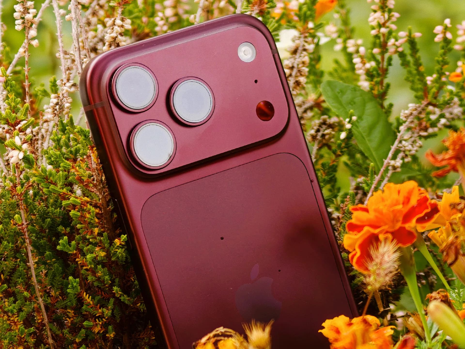 A rendered mockup of an iPhone 18 Pro with a titanium frame and pill-shaped Dynamic Island, shown against a dark gradient background.