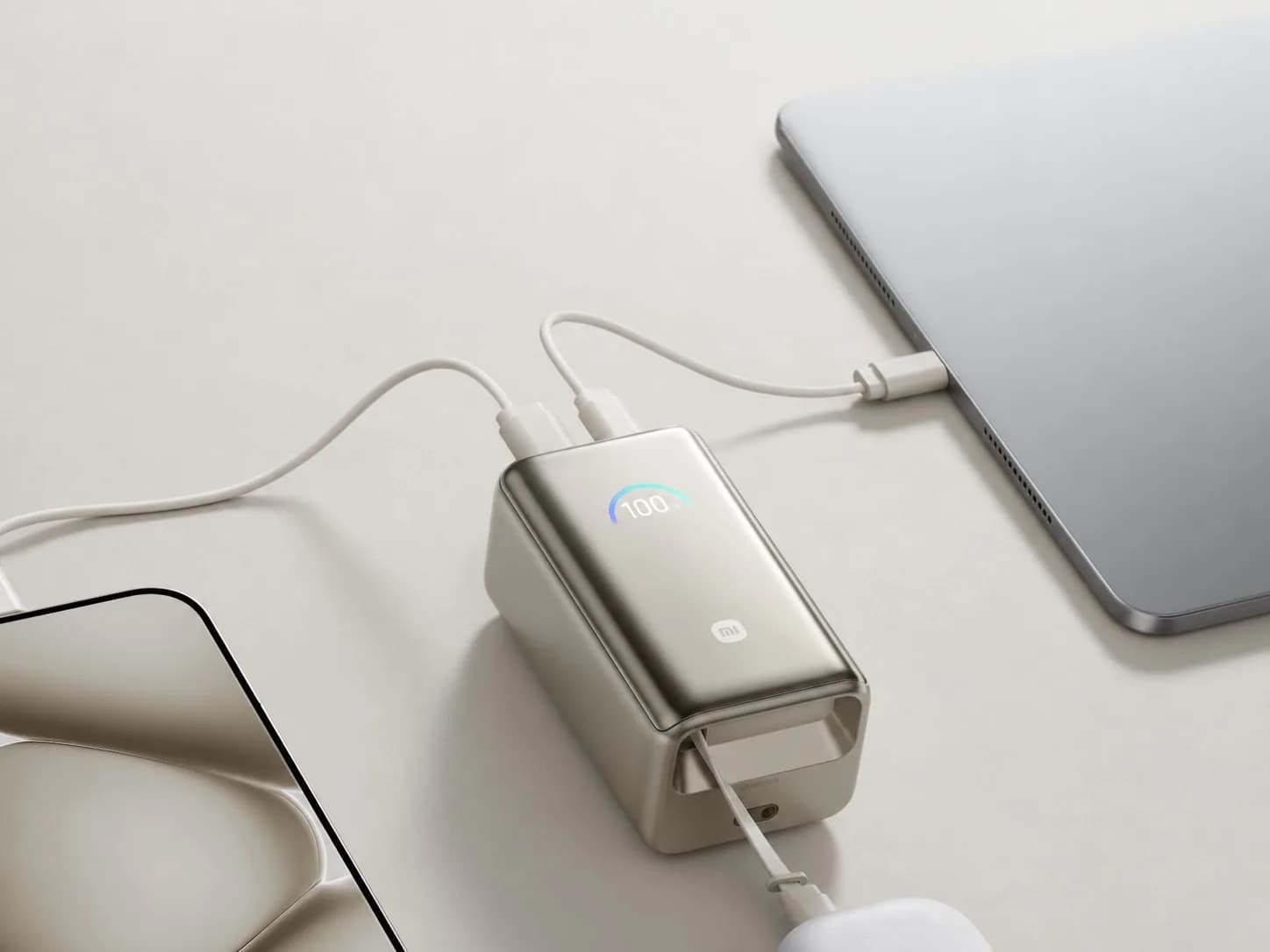 Xiaomi NPB1055R power bank in Titanium Gold, showing retractable USB-C cable extended and digital display lit.