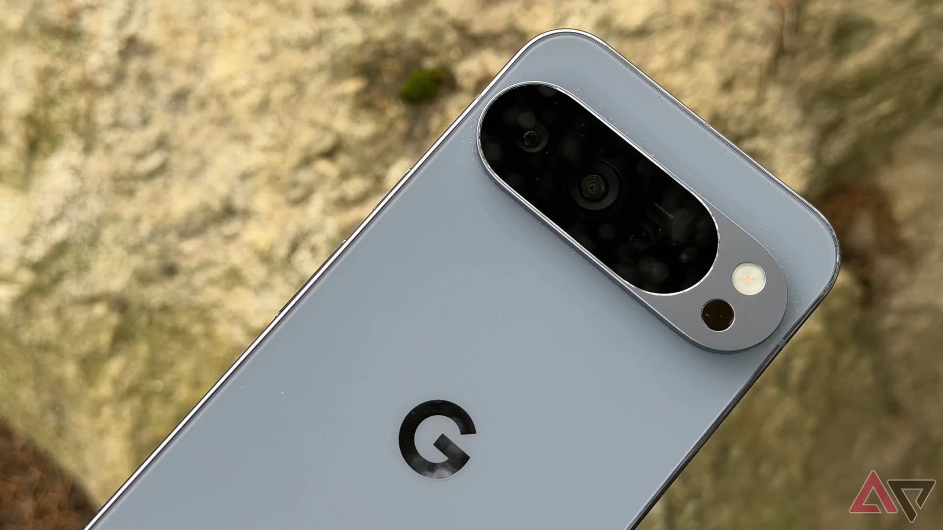 Google Pixel 10 smartphone resting on a desk displaying the Gboard voice typing interface.