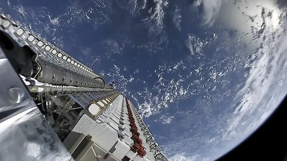 Elon Musk's Starlink satellite internet dish sitting on an outdoor mounting stand against a clear sky
