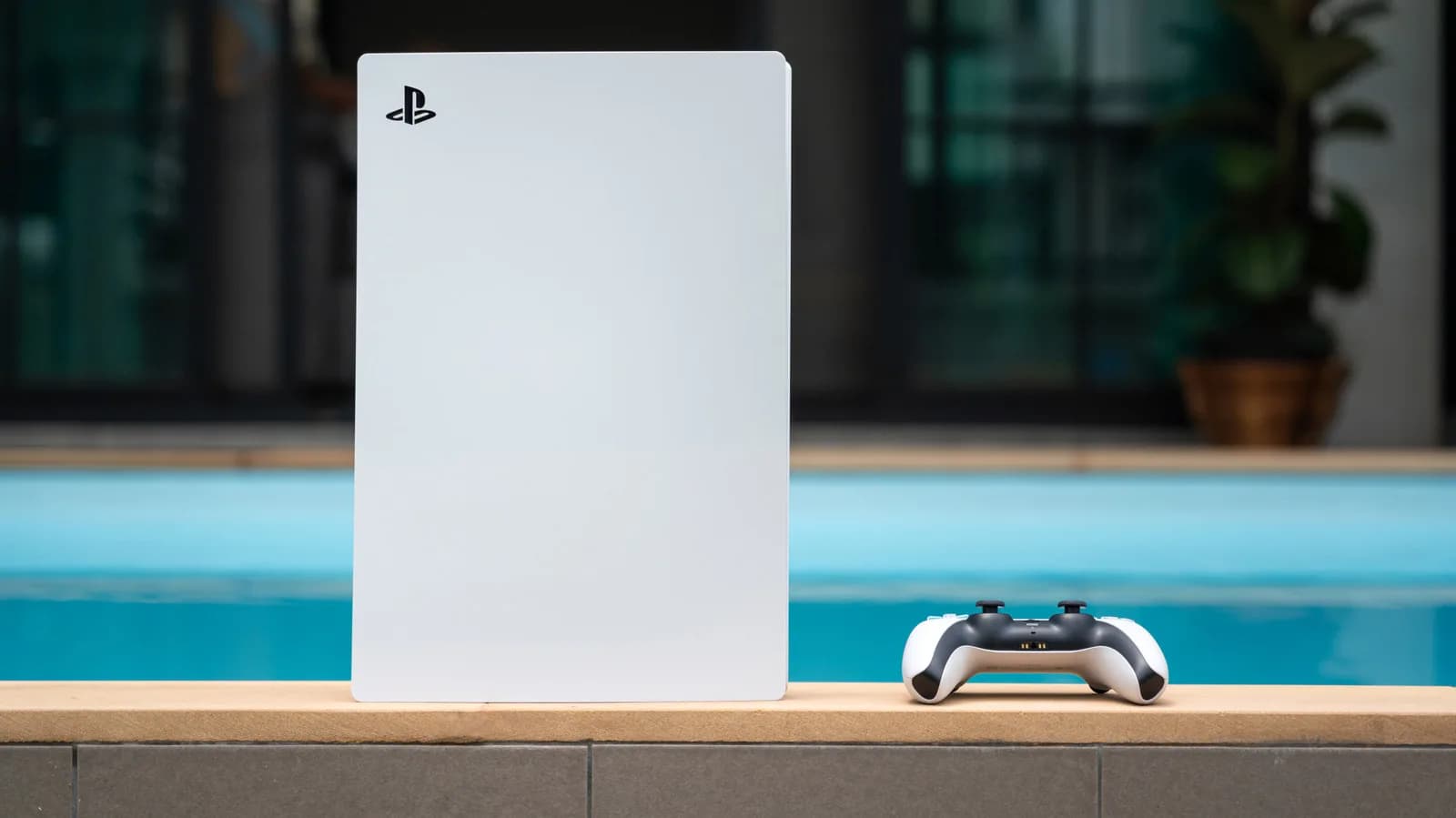A PlayStation 5 console standing upright next to an AMD Ryzen processor box.