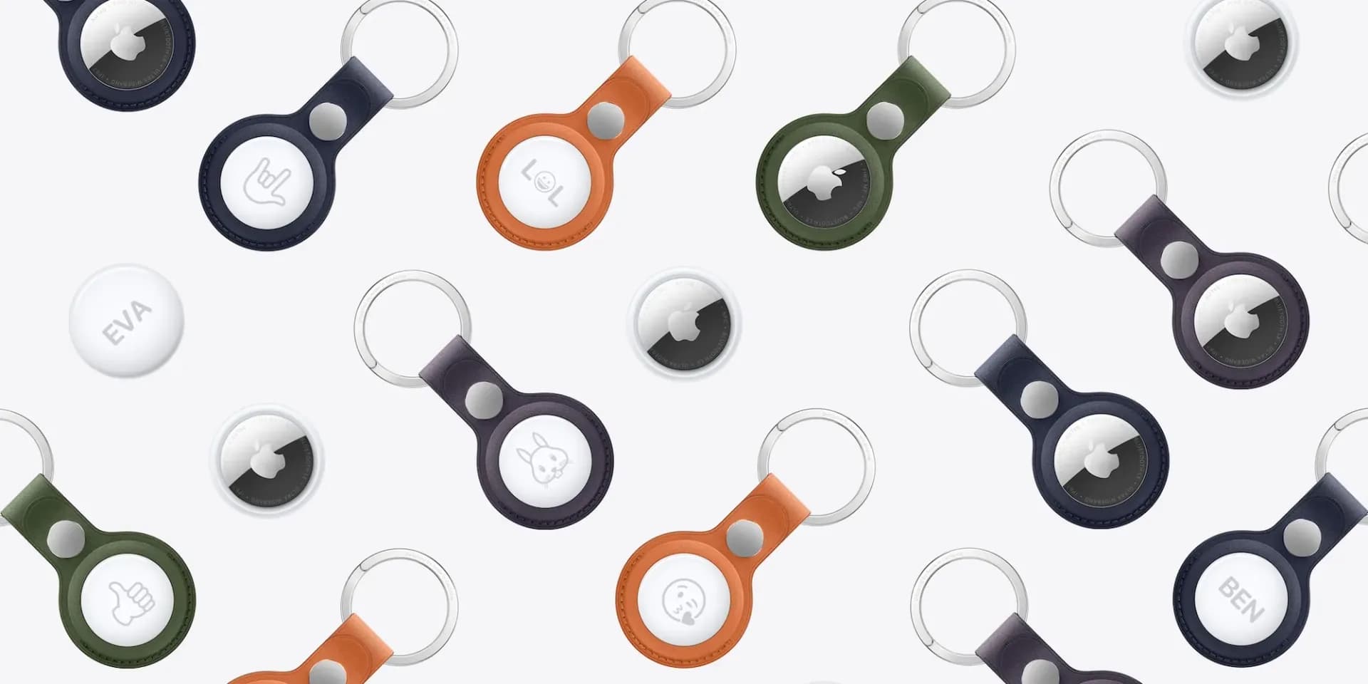 Black and Fox Orange Apple AirTag FineWoven Key Rings laid side by side on a white surface