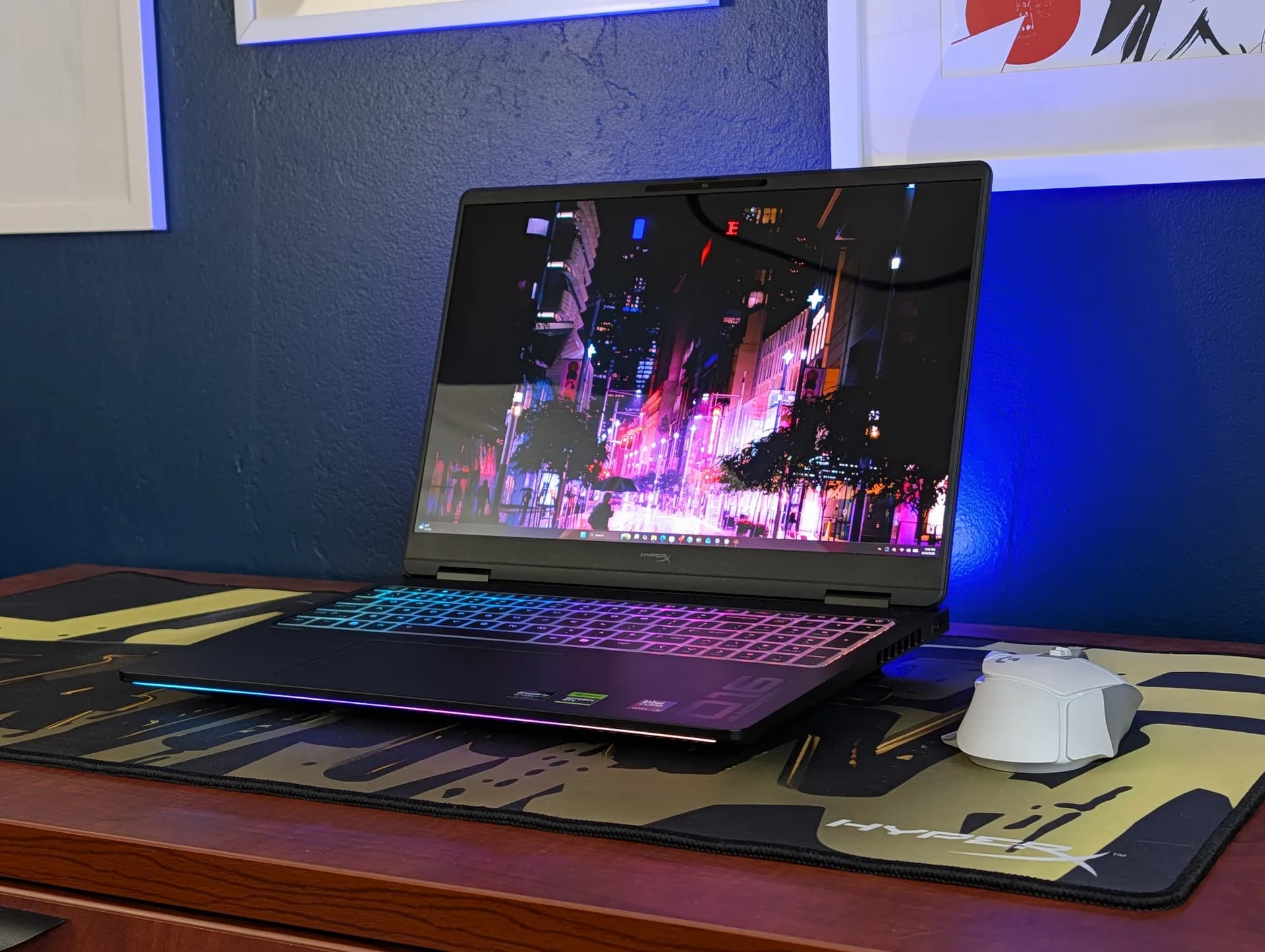 HP HyperX Omen Max 16 gaming laptop shown open with its large AC power adapter beside it