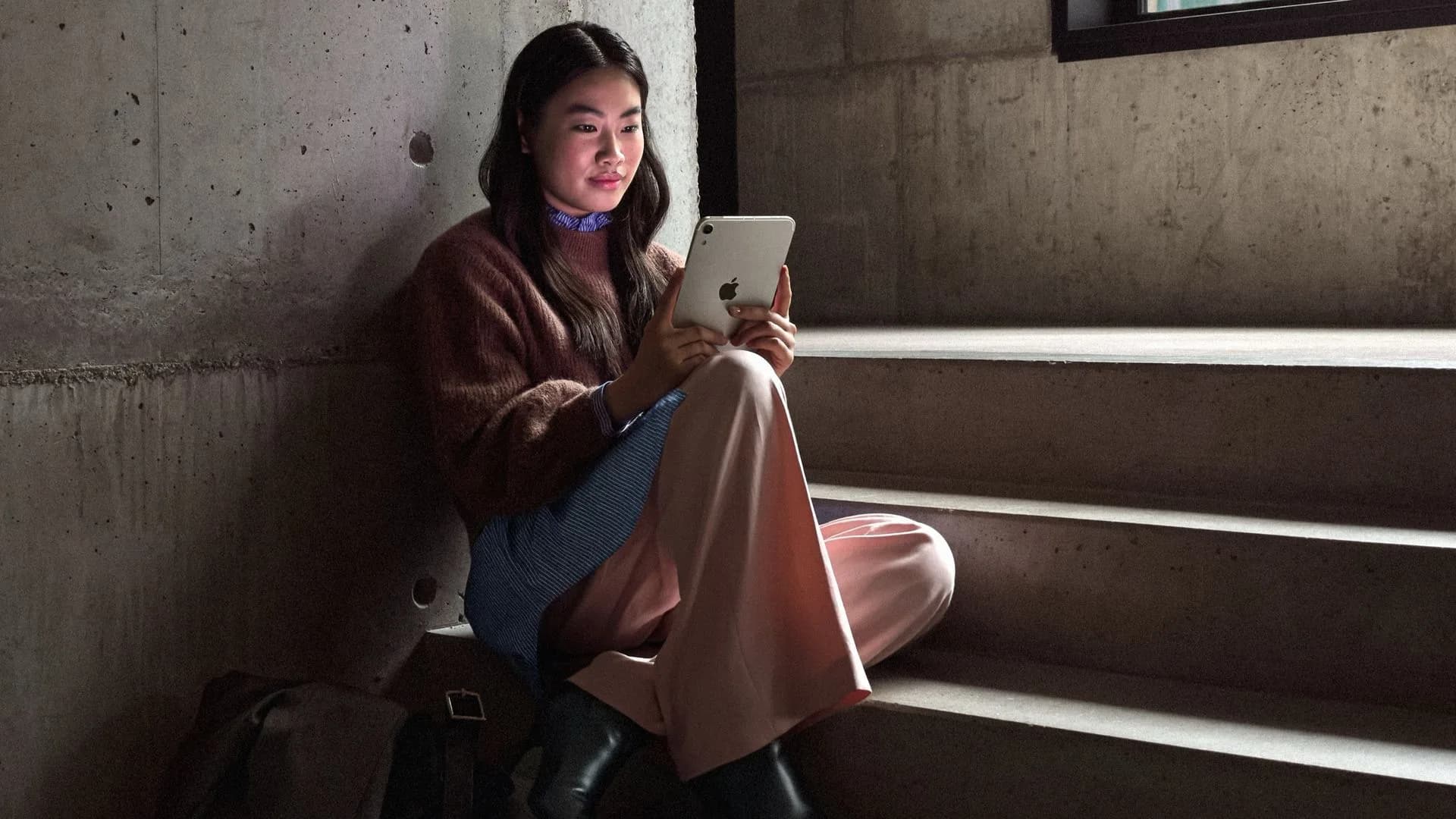 Apple's new iPad Mini in Midnight finish showing its OLED display and thin bezels