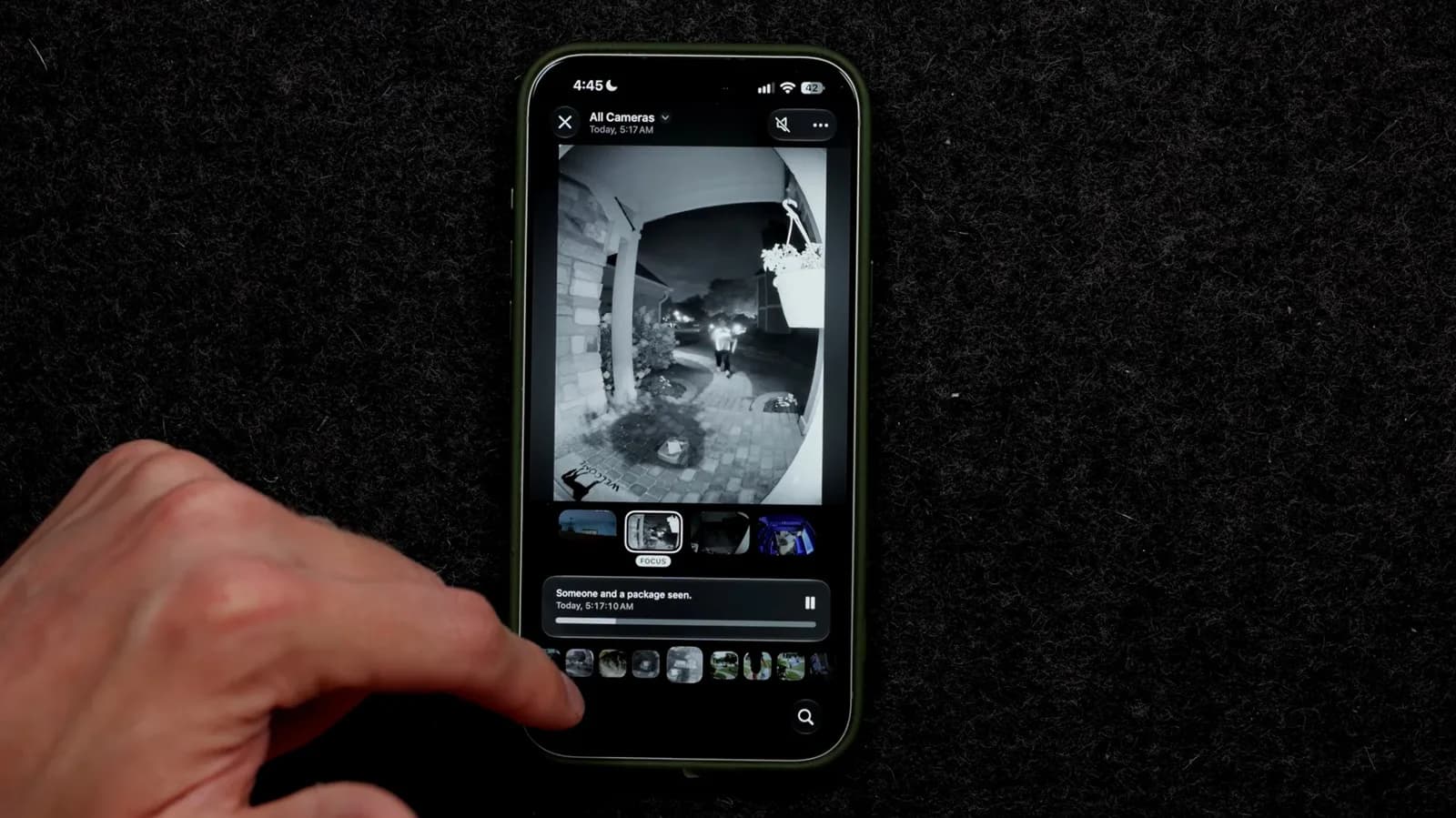 An Apple TV 4K and HomePod Mini beside a smartphone showing the Home app interface with Apple Intelligence toggles visible