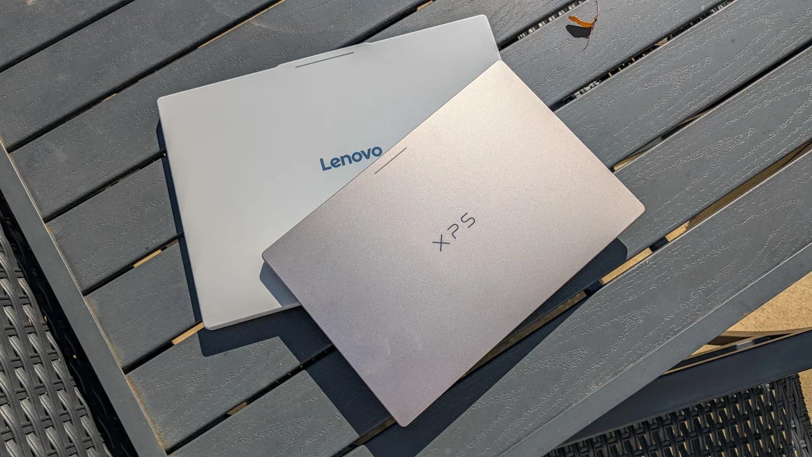 Dell XPS Googlebook open on a desk beside a Lenovo Googlebook laptop