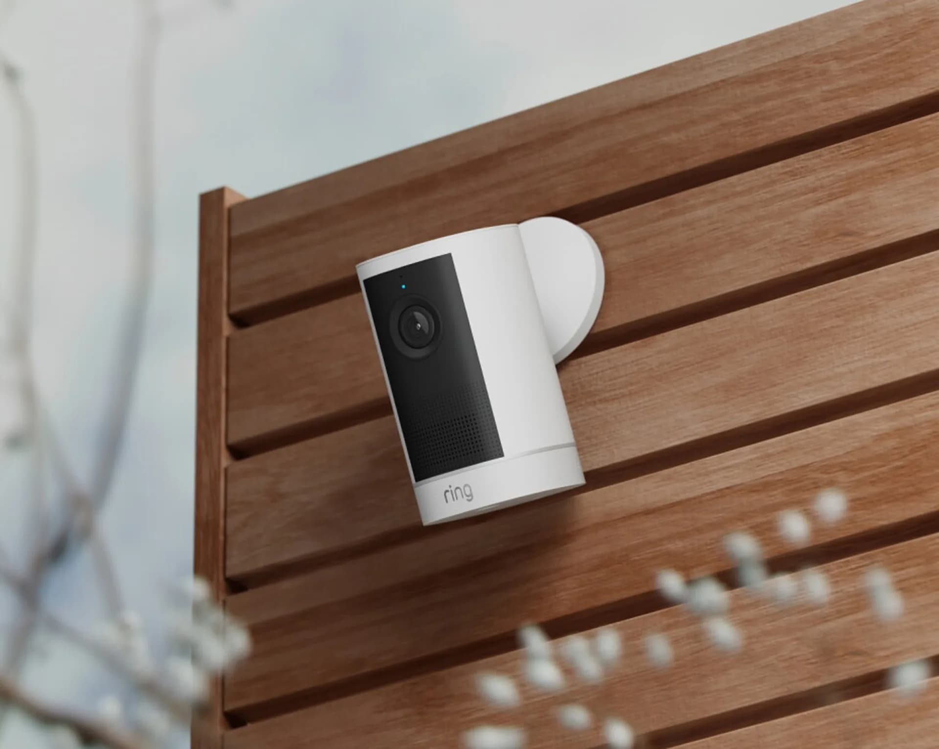 Ring smart home security camera mounted on a modern house wall.