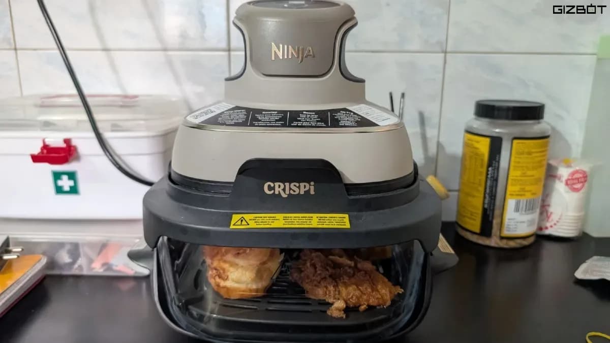 The Ninja Crispi modular glass air fryer displaying its transparent cooking container and top-mounted heating pod