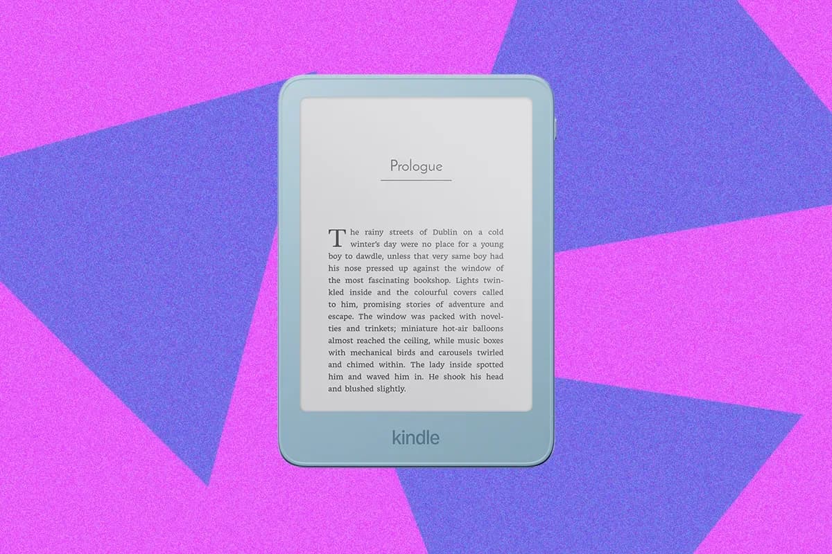 Amazon's Kindle Aluminum e-reader in Alpine Sky blue finish resting on a surface with its front light on.