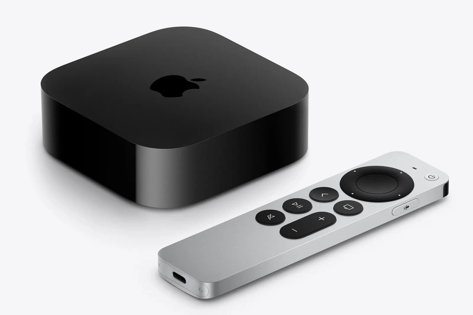 Apple TV 4K set-top box resting beside the silver Siri Remote