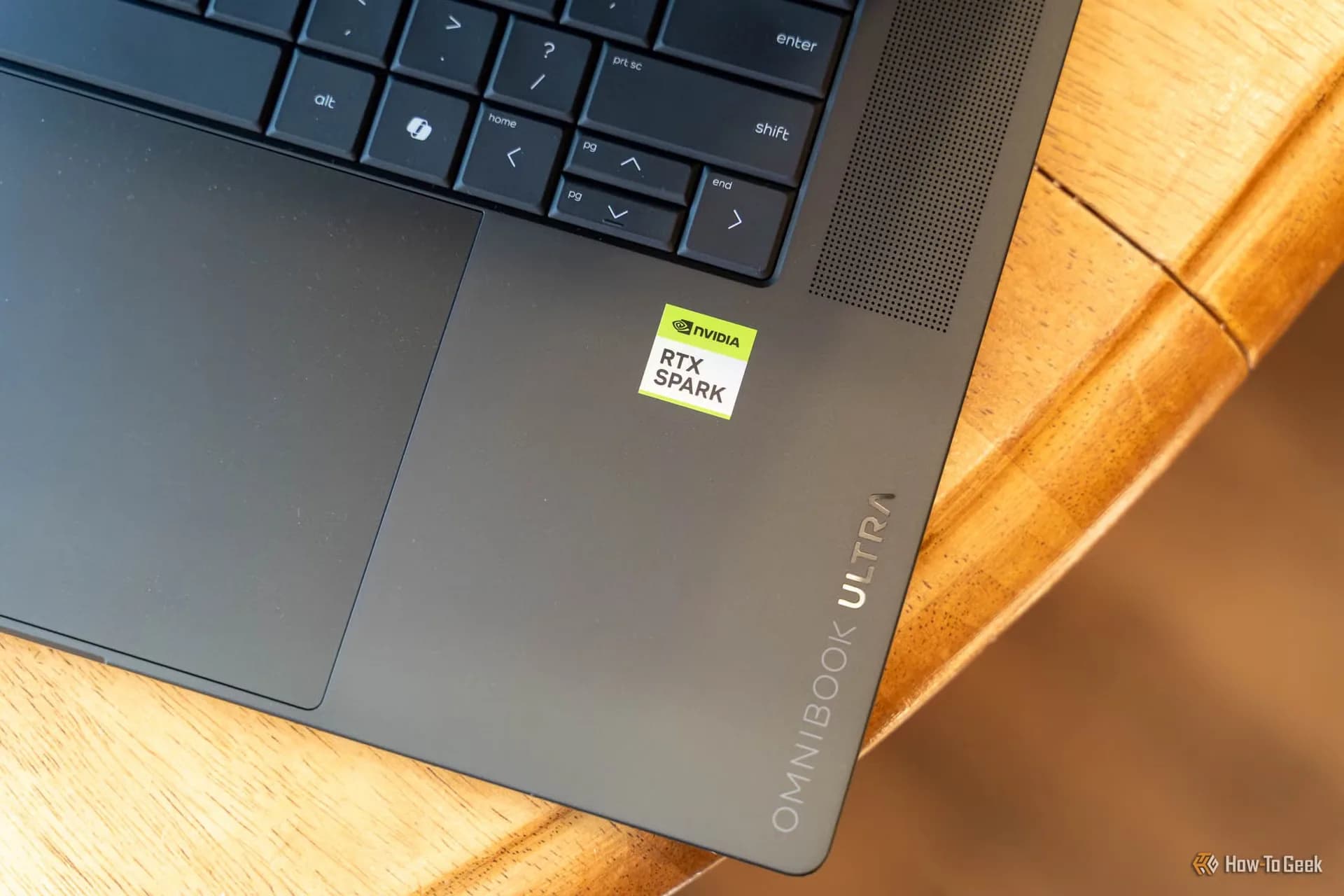 HP OmniBook Ultra 16 laptop with RTX Spark branding open on a desk showing its OLED display