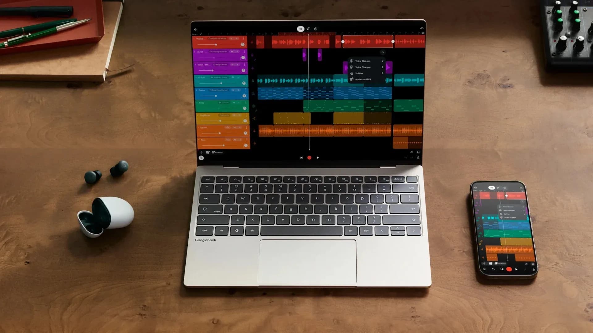 A Samsung Galaxy smartphone sitting on a desk next to a laptop displaying pairing settings.