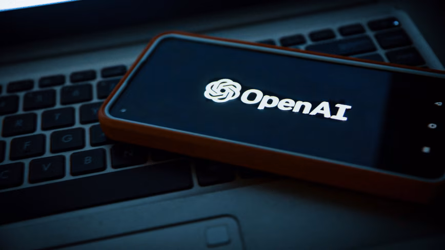 OpenAI corporate branding on a dark glass building exterior.