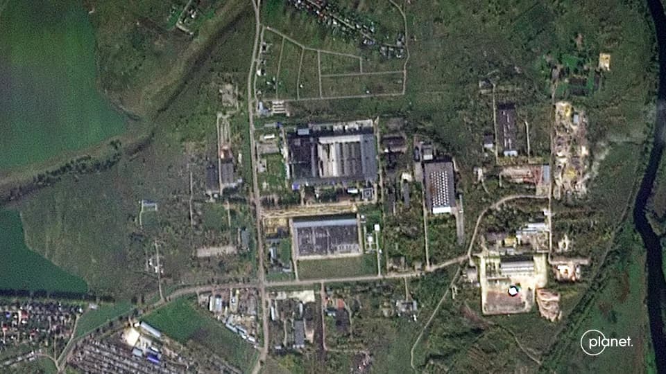 Exterior view of an industrial computing data center surrounded by security fencing