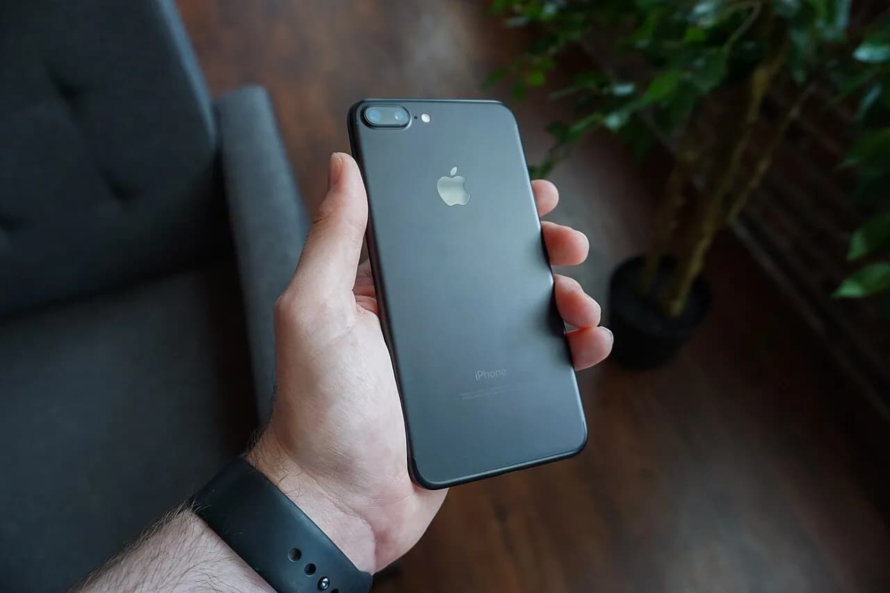 A black smartphone held in one hand