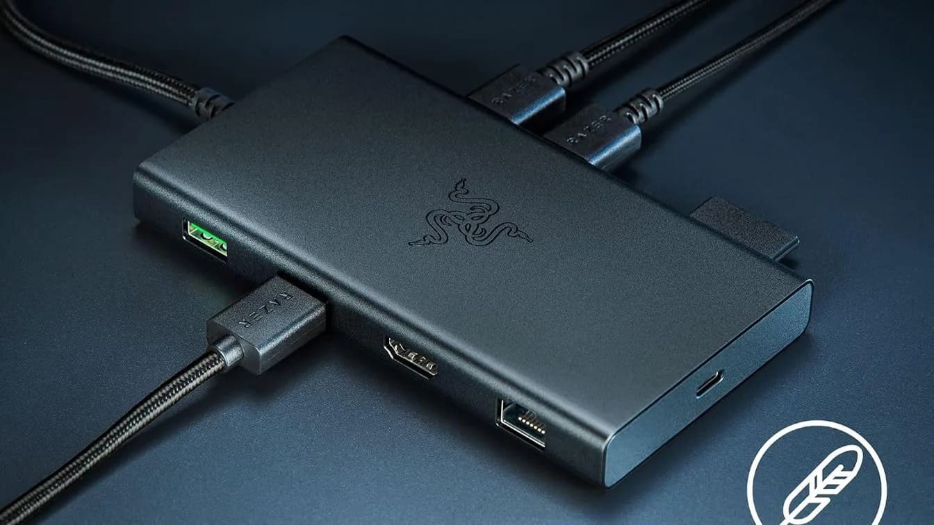Razer USB-C Dock 11-Port Travel Charging Station on a desk with laptop and cables
