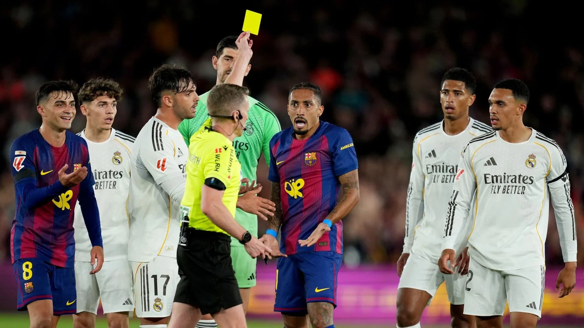 Barcelona and Real Madrid players contest a match during El Clasico