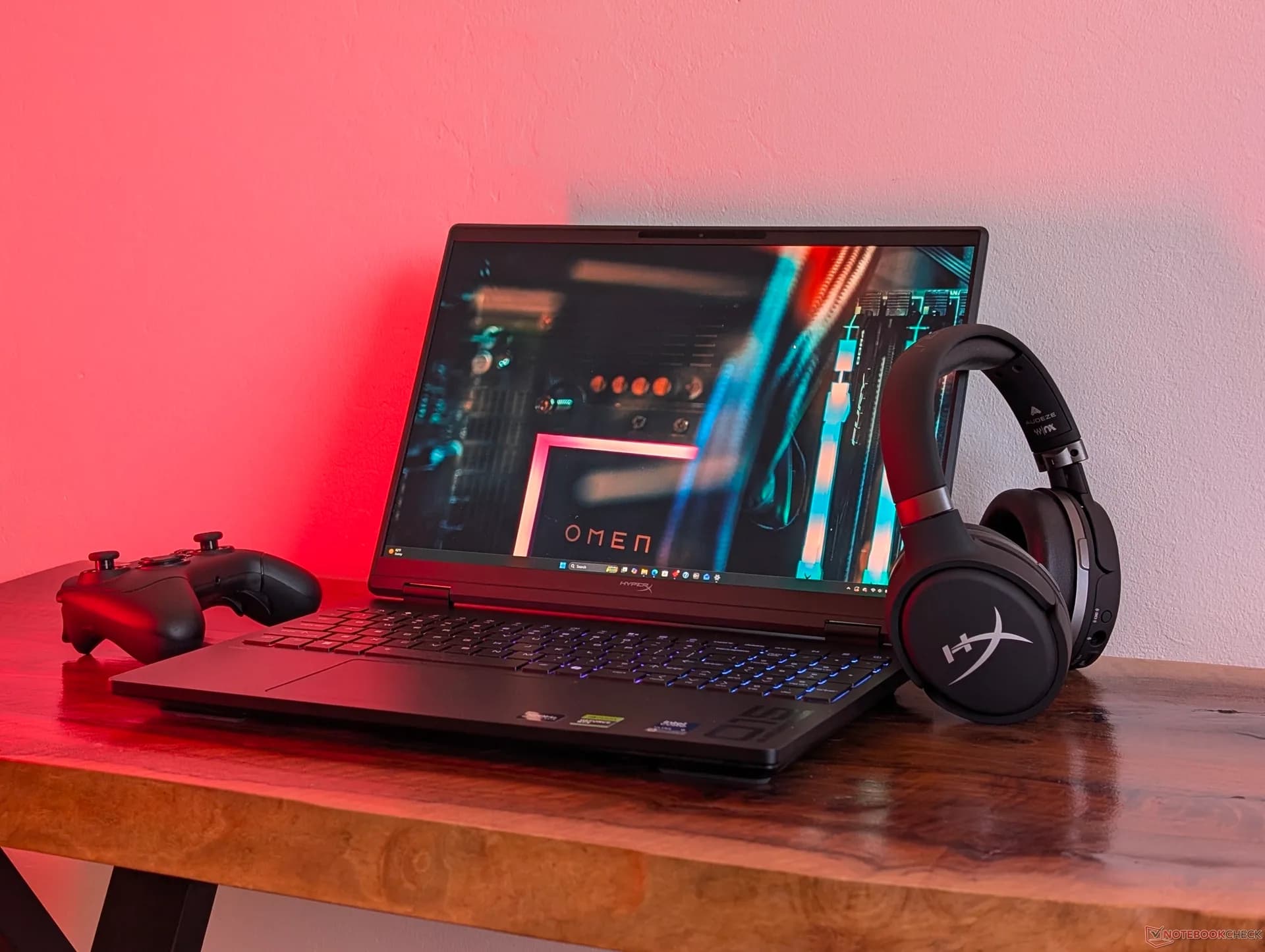 HP HyperX Omen 15 gaming laptop open on a desk showing the keyboard and display.