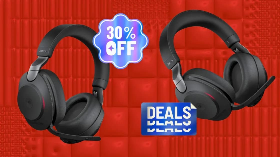 Jabra Evolve2 85 wireless over-ear headset with foldaway boom microphone resting on a wooden desk