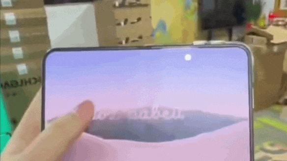 An iPhone Duo folding smartphone partially unfolded on display inside an Apple Store