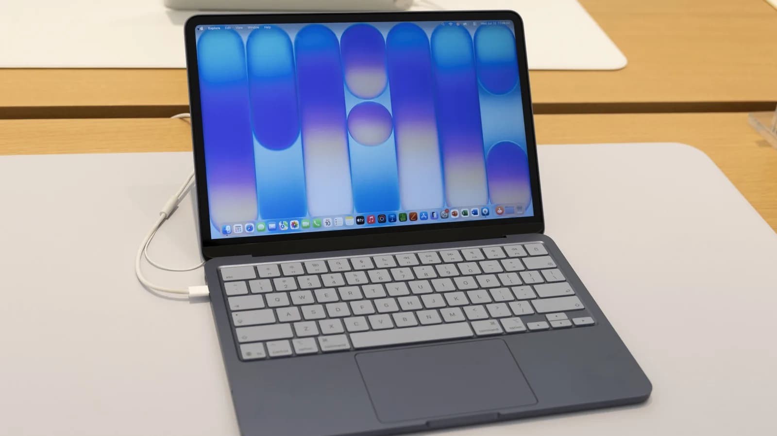 Apple MacBook Neo laptop shown open on a desk, displaying macOS on its 13-inch screen