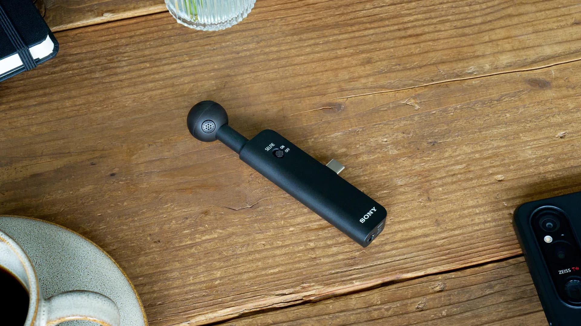 Sony ECM-AX10 microphone shown mounted on a smartphone