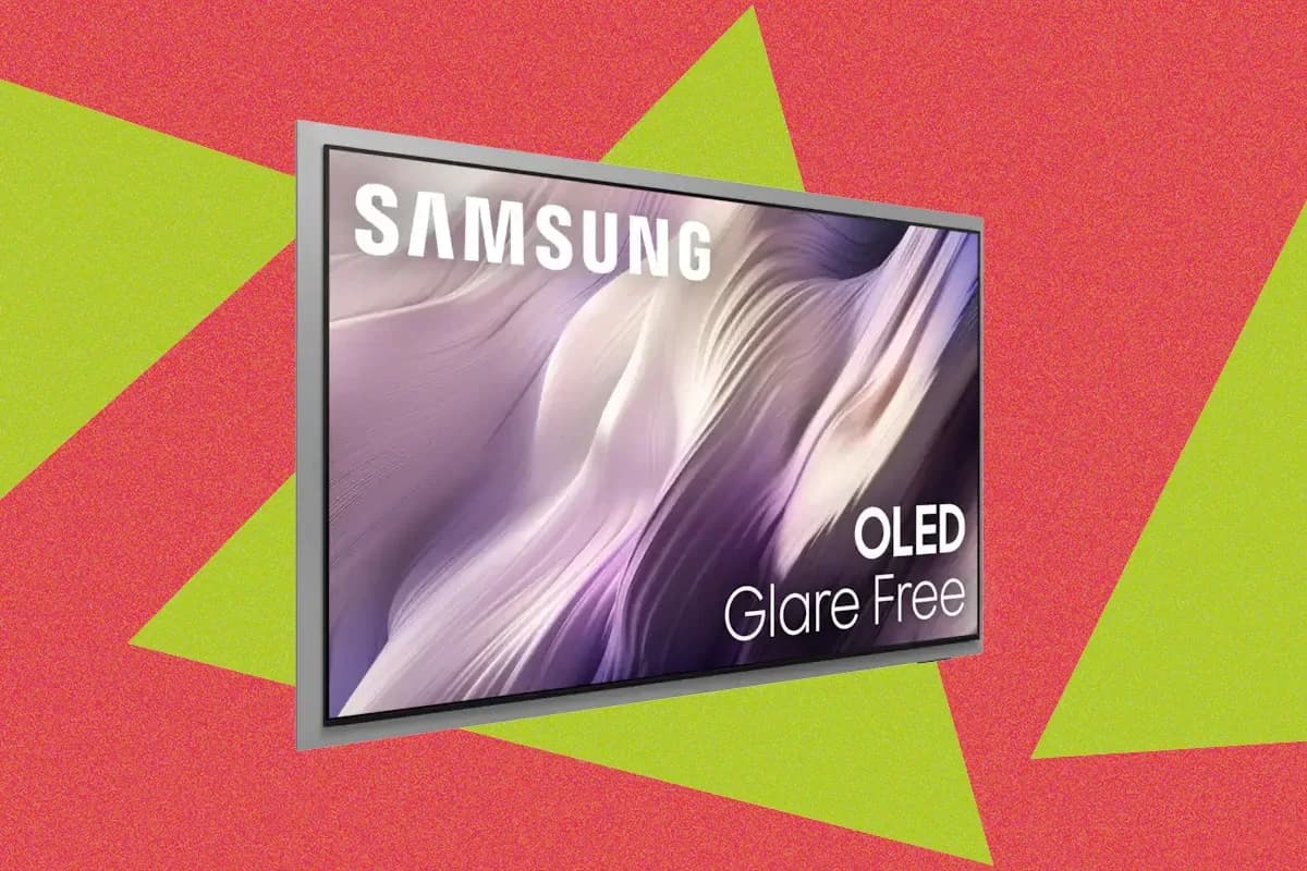 Samsung S95H OLED TV with a silver metal bezel mounted on a pedestal stand, displaying a bright colorful scene.