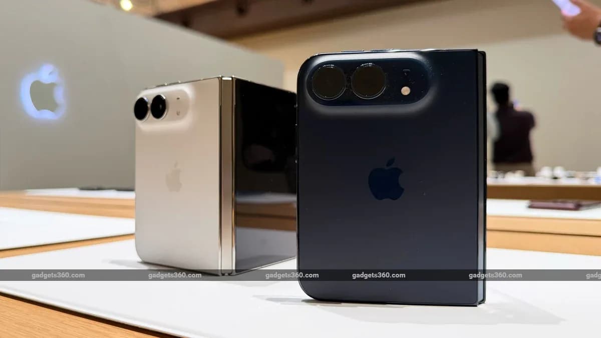 An Apple Store window display with demo units under bright lighting
