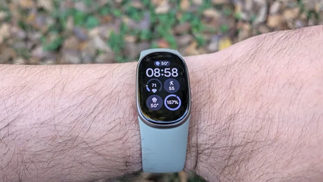 A Fitbit Edge fitness tracker with a bright AMOLED display showing heart rate and workout stats on a wrist.