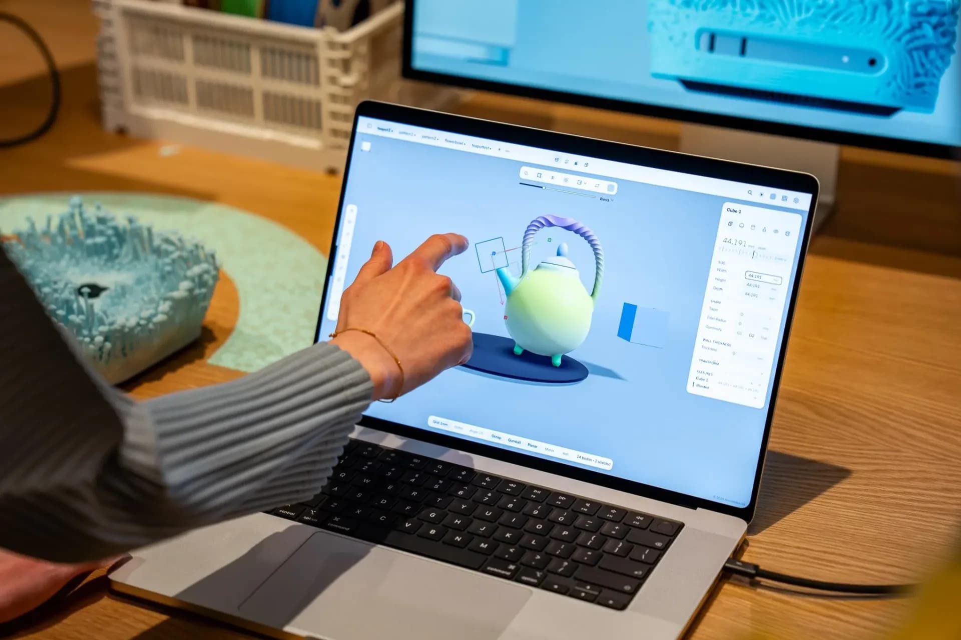 Apple MacBook Pro with PROLED XDR Display open, showing its OLED screen and glowing Apple logo on the lid